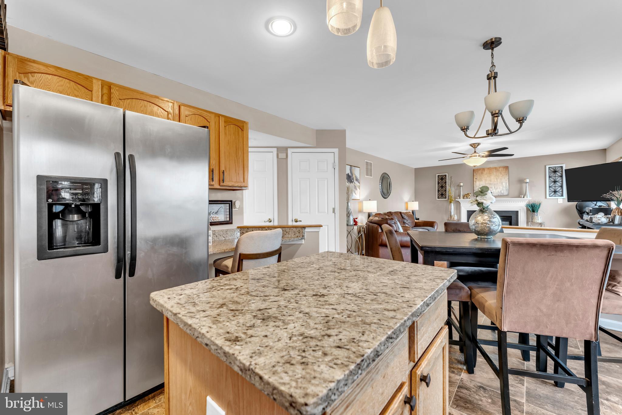 5660 Compton Lane Eldersburg, MD 21784 - Photo 18 of 44 a kitchen with a table chairs refrigerator and microwave