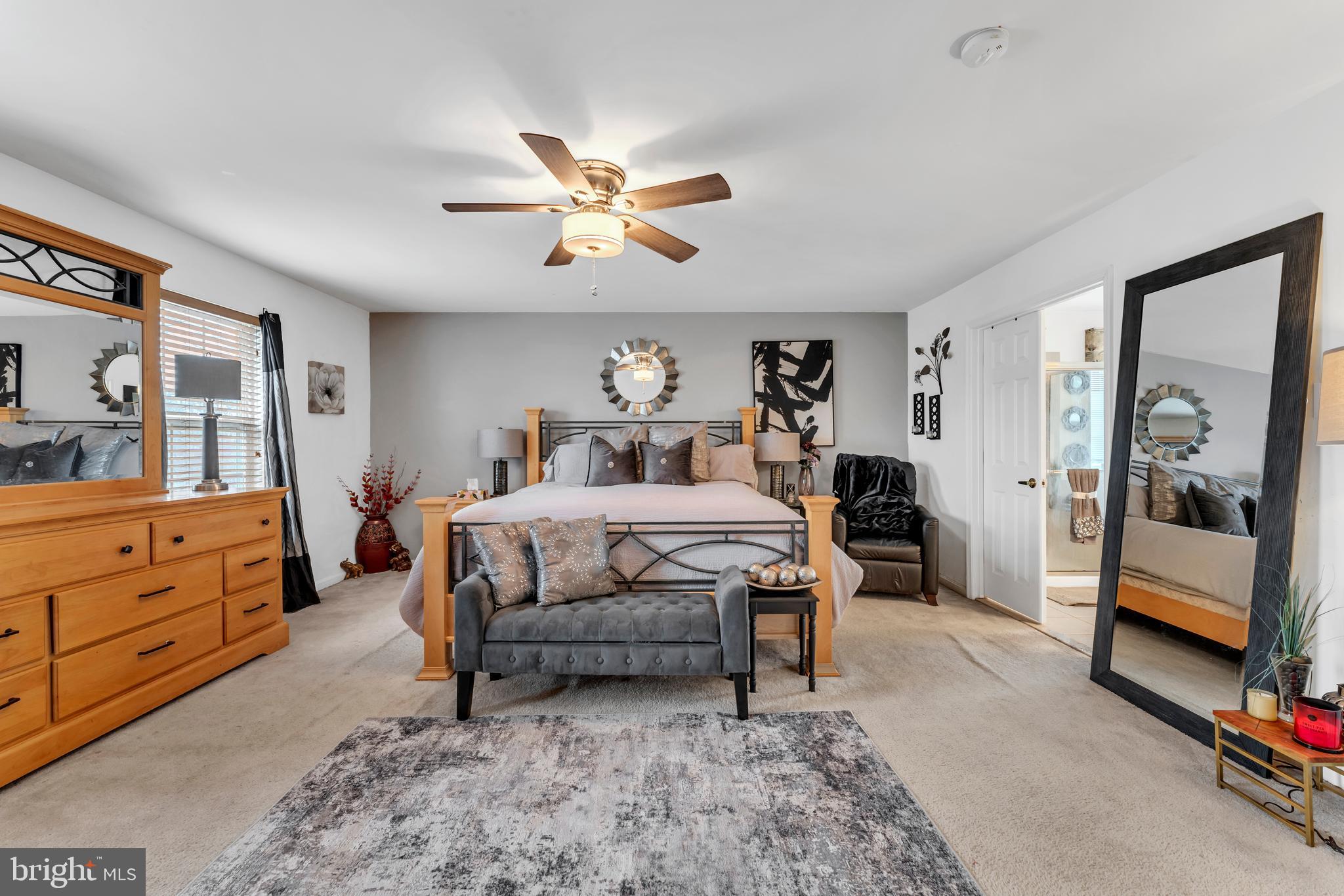 5660 Compton Lane Eldersburg, MD 21784 - Photo 21 of 44 a bedroom with a bed and a chandelier