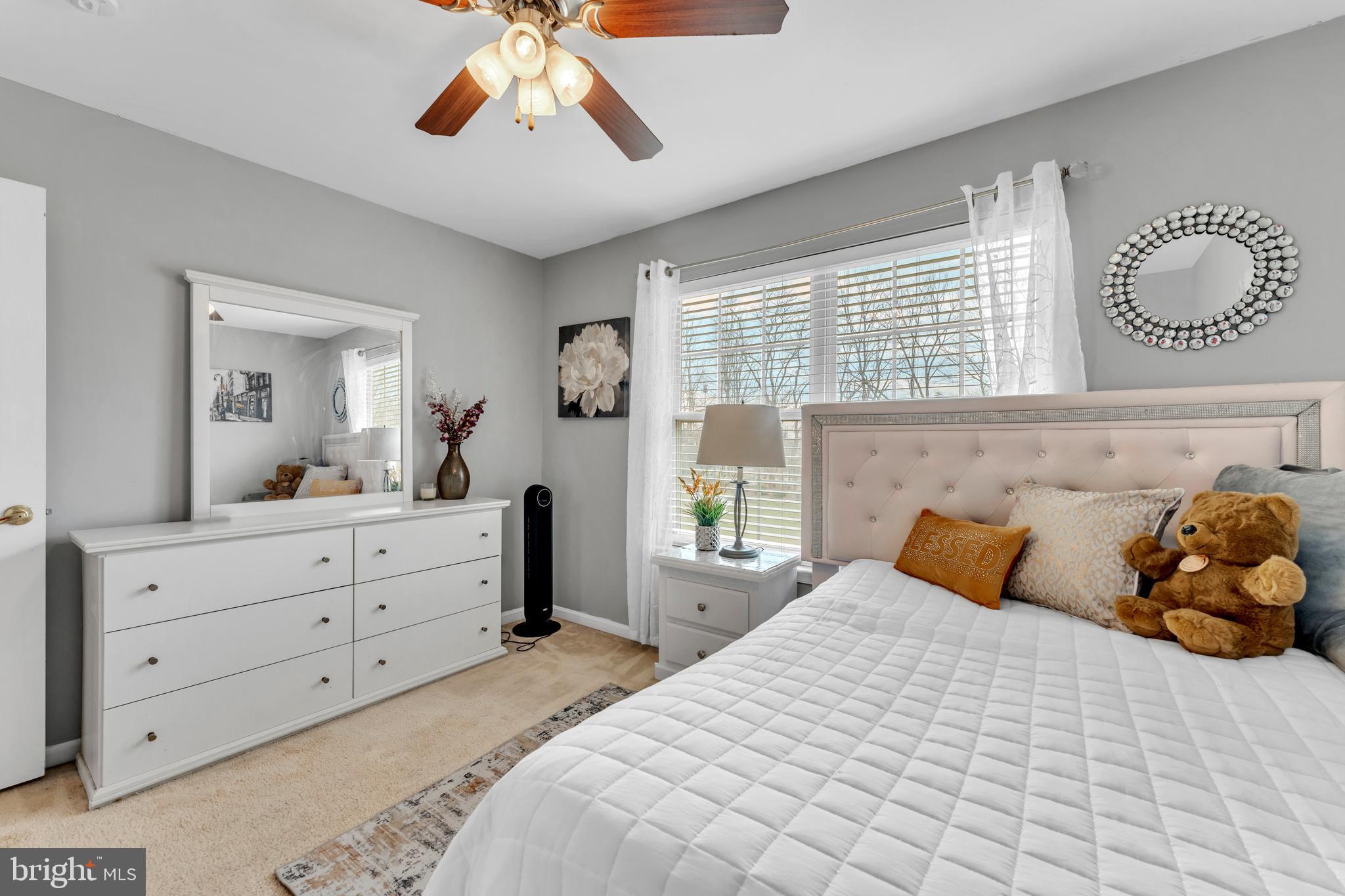 5660 Compton Lane Eldersburg, MD 21784 - Photo 32 of 44 a bedroom with a large bed and a mirror on dresser