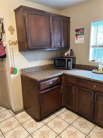 a kitchen with granite countertop a stove and cabinets