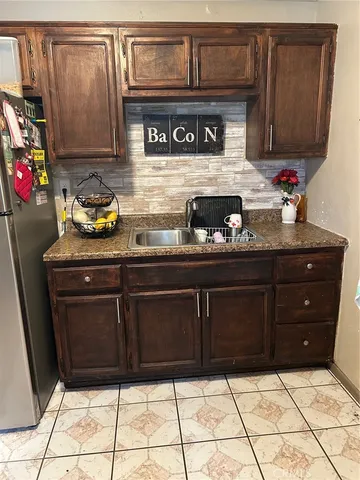 a kitchen with stainless steel appliances granite countertop a sink and cabinets