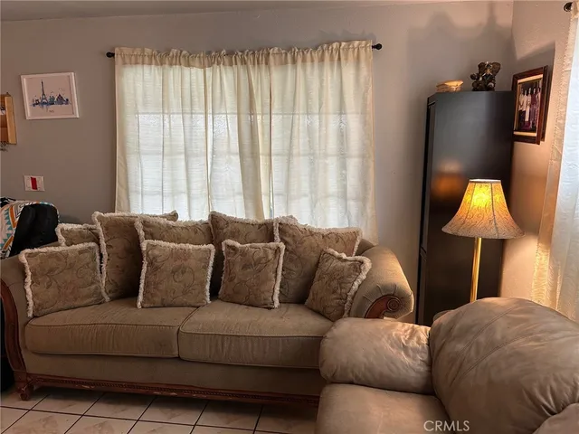 a living room with furniture and a lamp