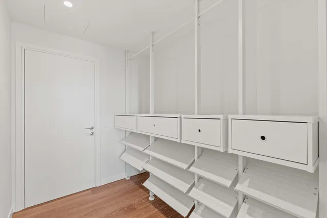 a view of cabinets and patio with wooden floor