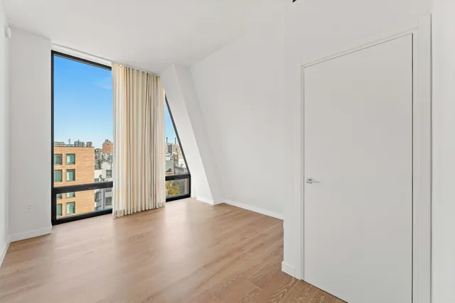 a bedroom with a bed and flat screen tv