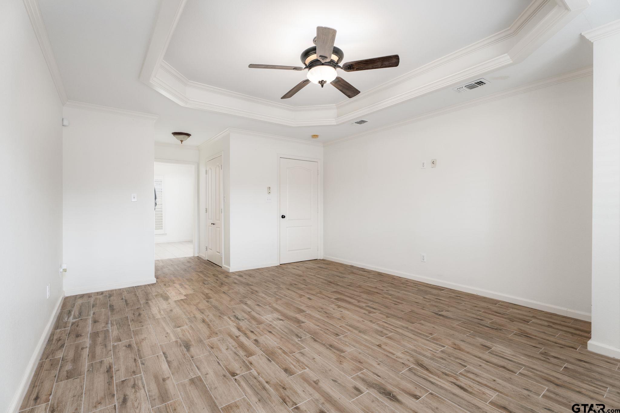 353 Deer Creek Road Big Sandy, TX 75755 - Photo 12 of 30 a view of a room with wooden floor and a ceiling fan