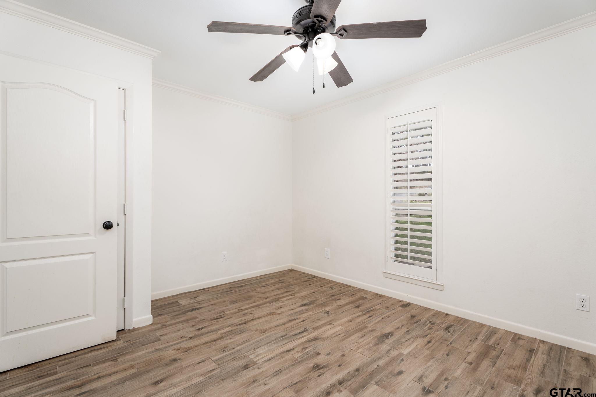 353 Deer Creek Road Big Sandy, TX 75755 - Photo 16 of 30 an empty room with wooden floor closet and windows