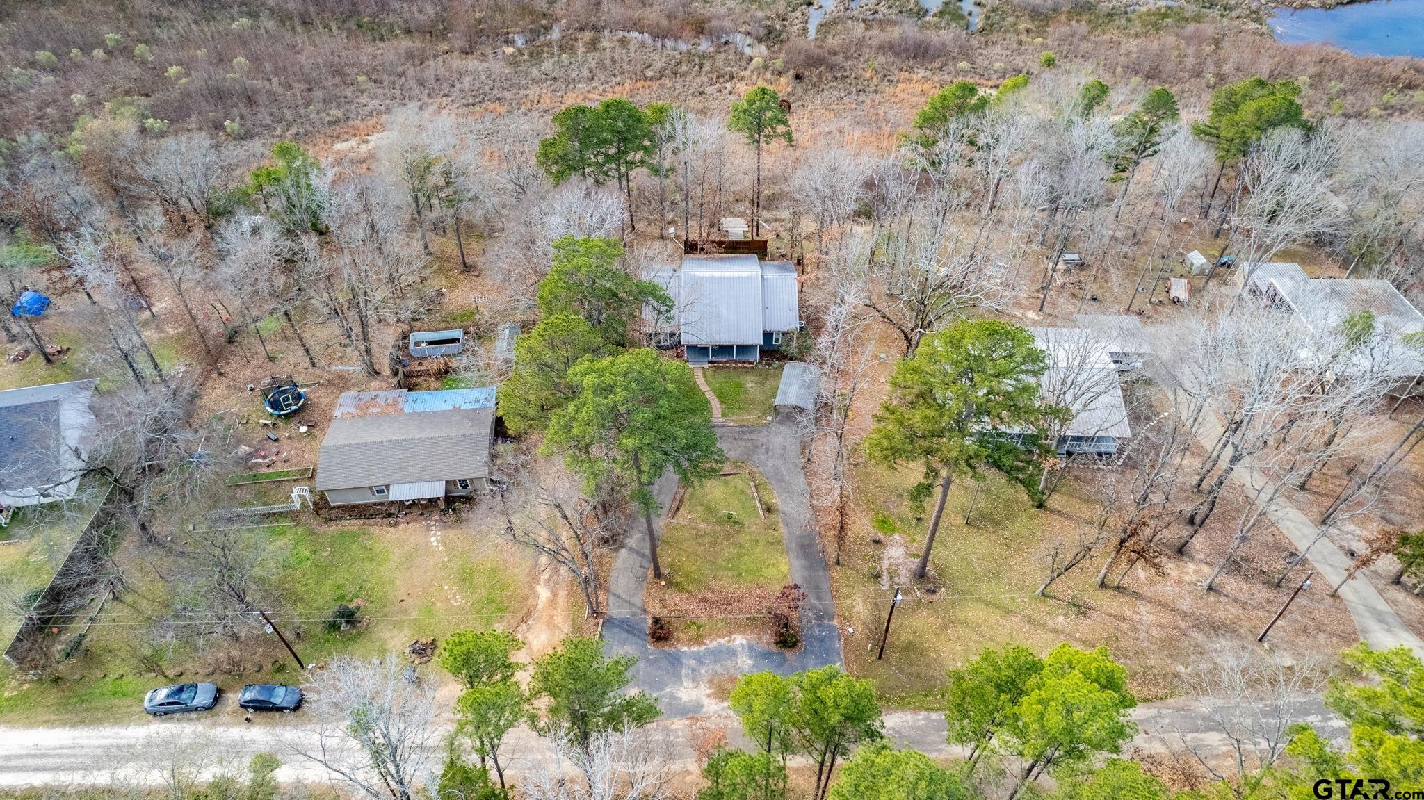353 Deer Creek Road Big Sandy, TX 75755 - Photo 26 of 30 an aerial view of a house with a garden and mountain view