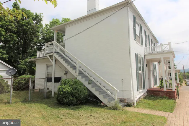 a view of a house with backyard and deck