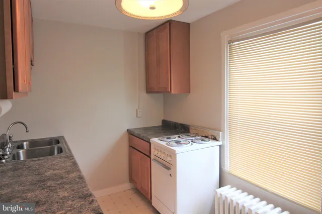 a utility room with sink dryer and washer
