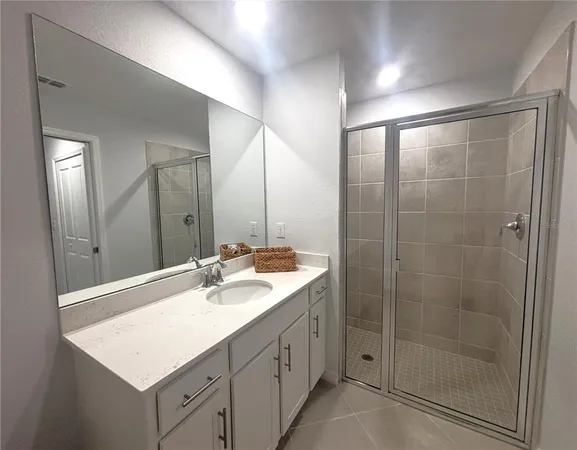 a bathroom with a sink double vanity and a mirror