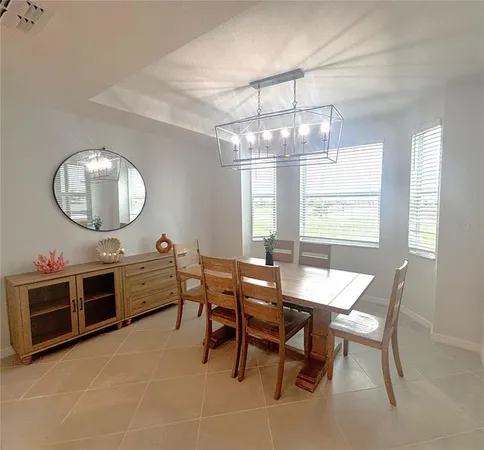 a view of a dining room with furniture and chandelier kitchen