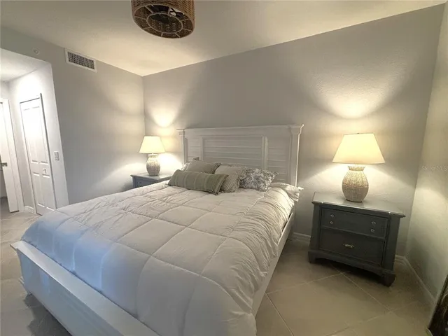 a bedroom with a bed and a lamp
