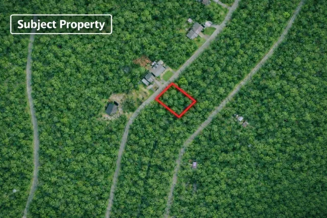 a sign that is on a lush green field