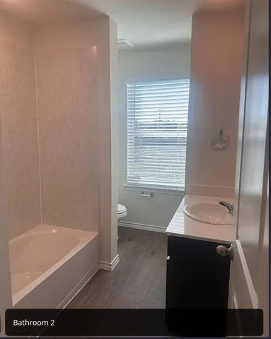 a bathroom with a bathtub and a sink