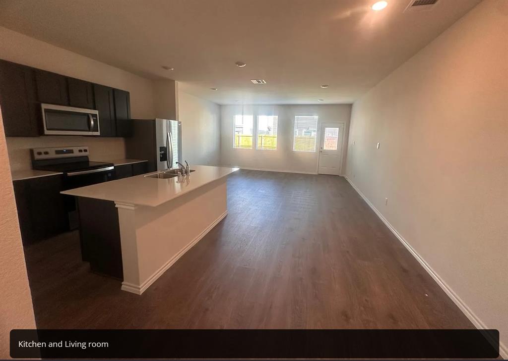 6015 Pinion Trail Princeton, TX 75407 - Photo 17 of 17 a living room with stainless steel appliances kitchen island granite countertop a refrigerator a stove top oven a sink and dishwasher