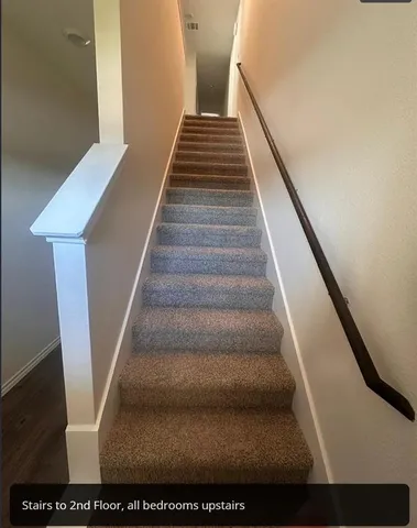 a living room with stainless steel appliances kitchen island granite countertop a refrigerator a stove top oven a sink and dishwasher