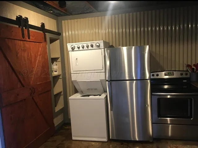 a kitchen with a refrigerator and a stove