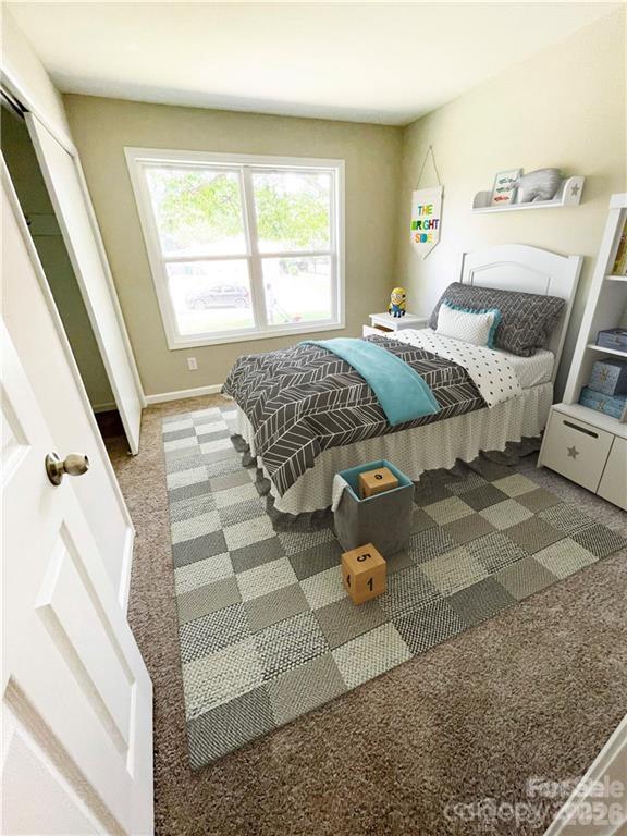 3826 Langley Road Charlotte, NC 28215 - Photo 6 of 15 a bedroom with a bed and wooden floor