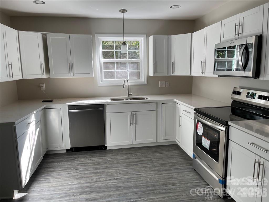 3826 Langley Road Charlotte, NC 28215 - Photo 8 of 15 a kitchen with a stove sink and microwave