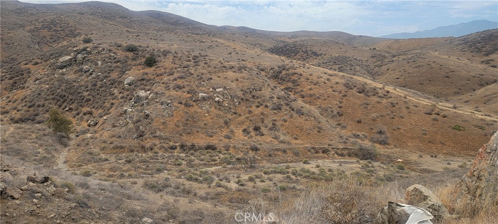 0 Cajalco Road Corona, CA 92881 - Photo 1 of 8 a view of a dry yard with mountains in the background