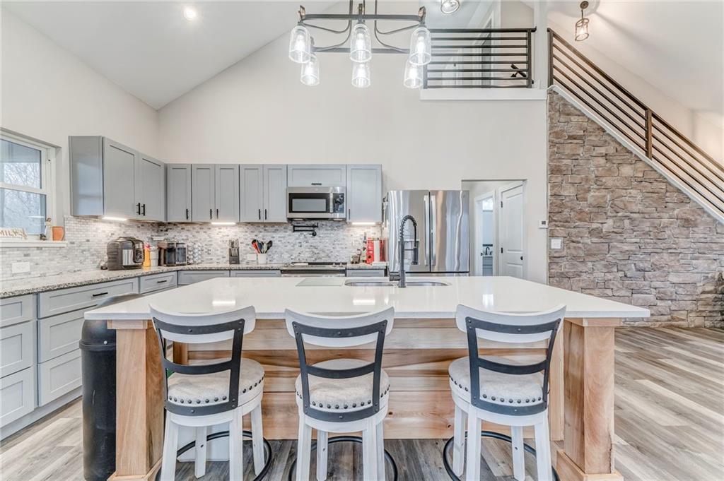 1172 Hunter Drive Ranger, GA 30734 - Photo 20 of 71 a kitchen with stainless steel appliances a white table chairs and a refrigerator