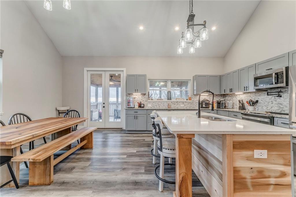 1172 Hunter Drive Ranger, GA 30734 - Photo 22 of 71 a kitchen with stainless steel appliances granite countertop a lot of counter space and wooden floor