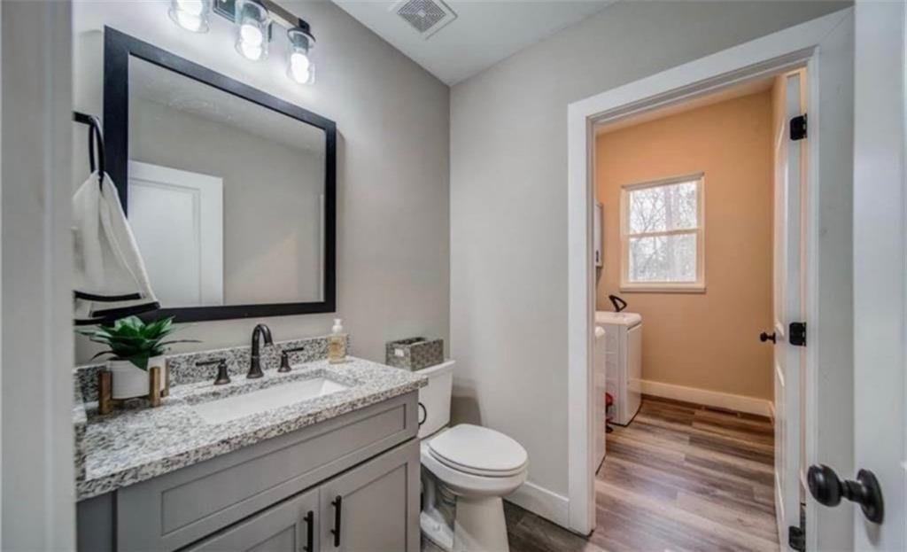 1172 Hunter Drive Ranger, GA 30734 - Photo 31 of 71 a bathroom with a granite countertop sink toilet and mirror