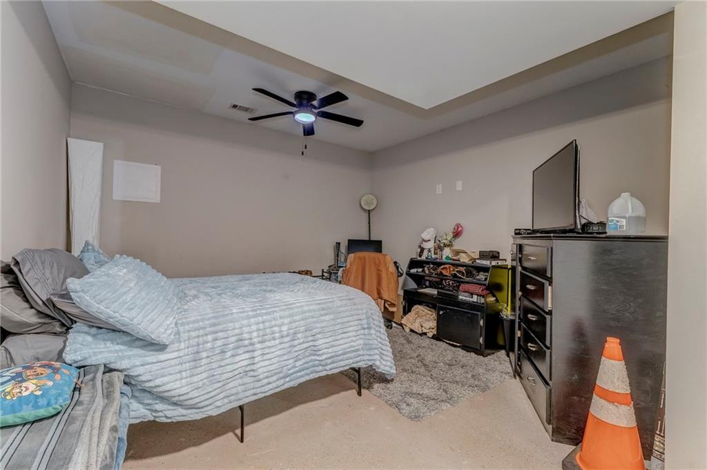 1172 Hunter Drive Ranger, GA 30734 - Photo 57 of 71 a bedroom with a bed and a chandelier