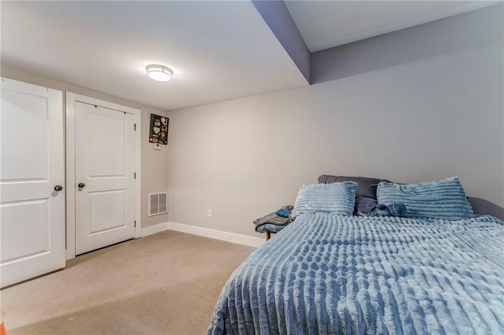 1172 Hunter Drive Ranger, GA 30734 - Photo 58 of 71 a bedroom with a large bed and a chandelier fan