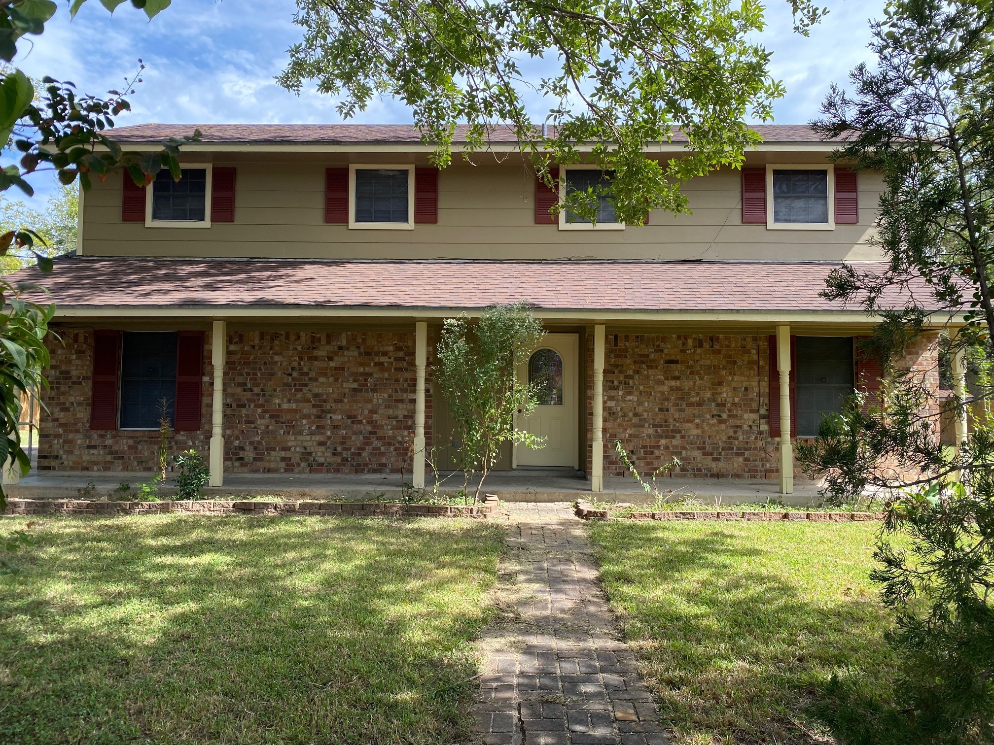 a front view of a house with a garden