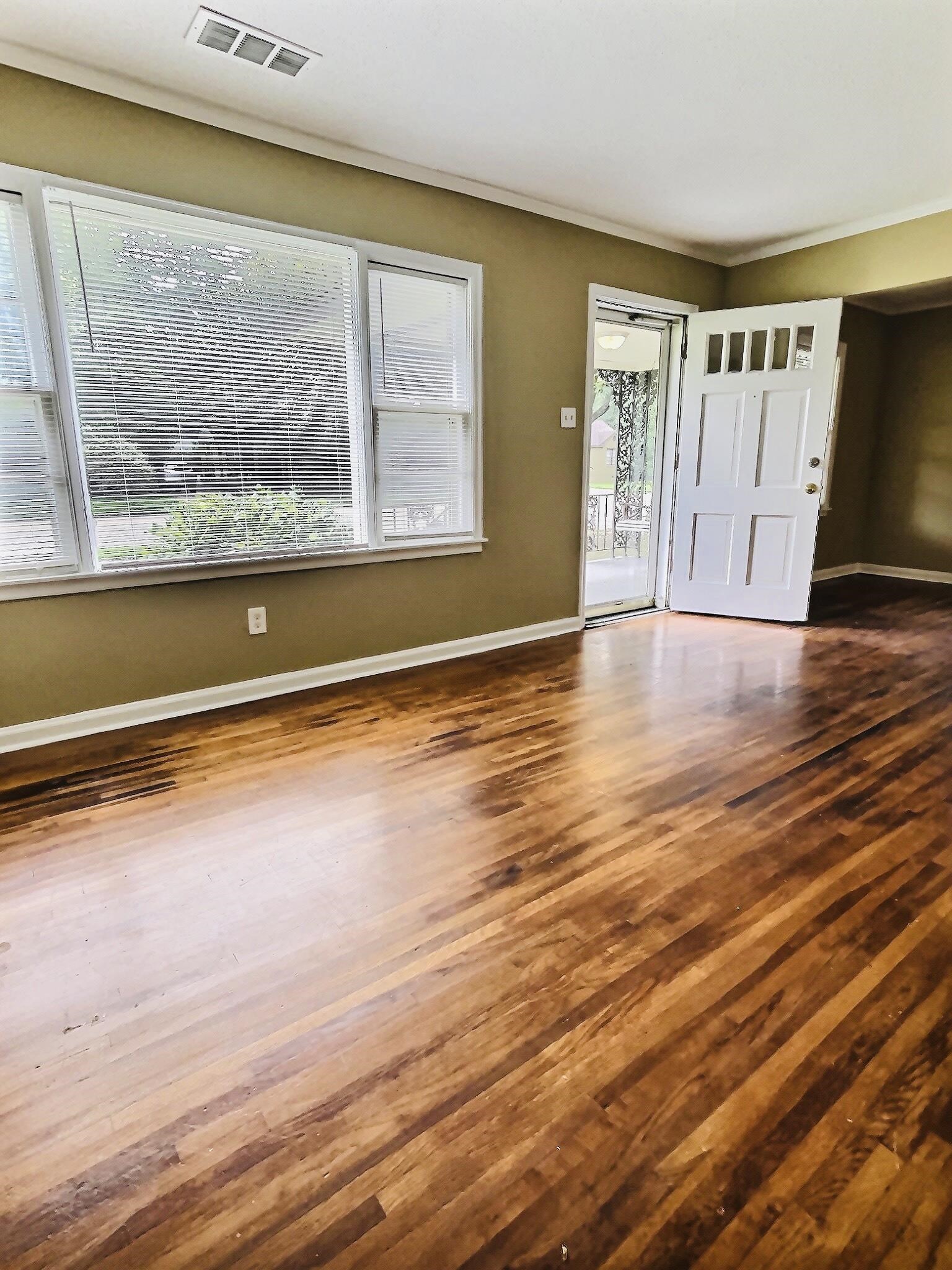 1405 South Perkins Road Memphis, TN 38117 - Photo 2 of 17 a view of an empty room with wooden floor and a window