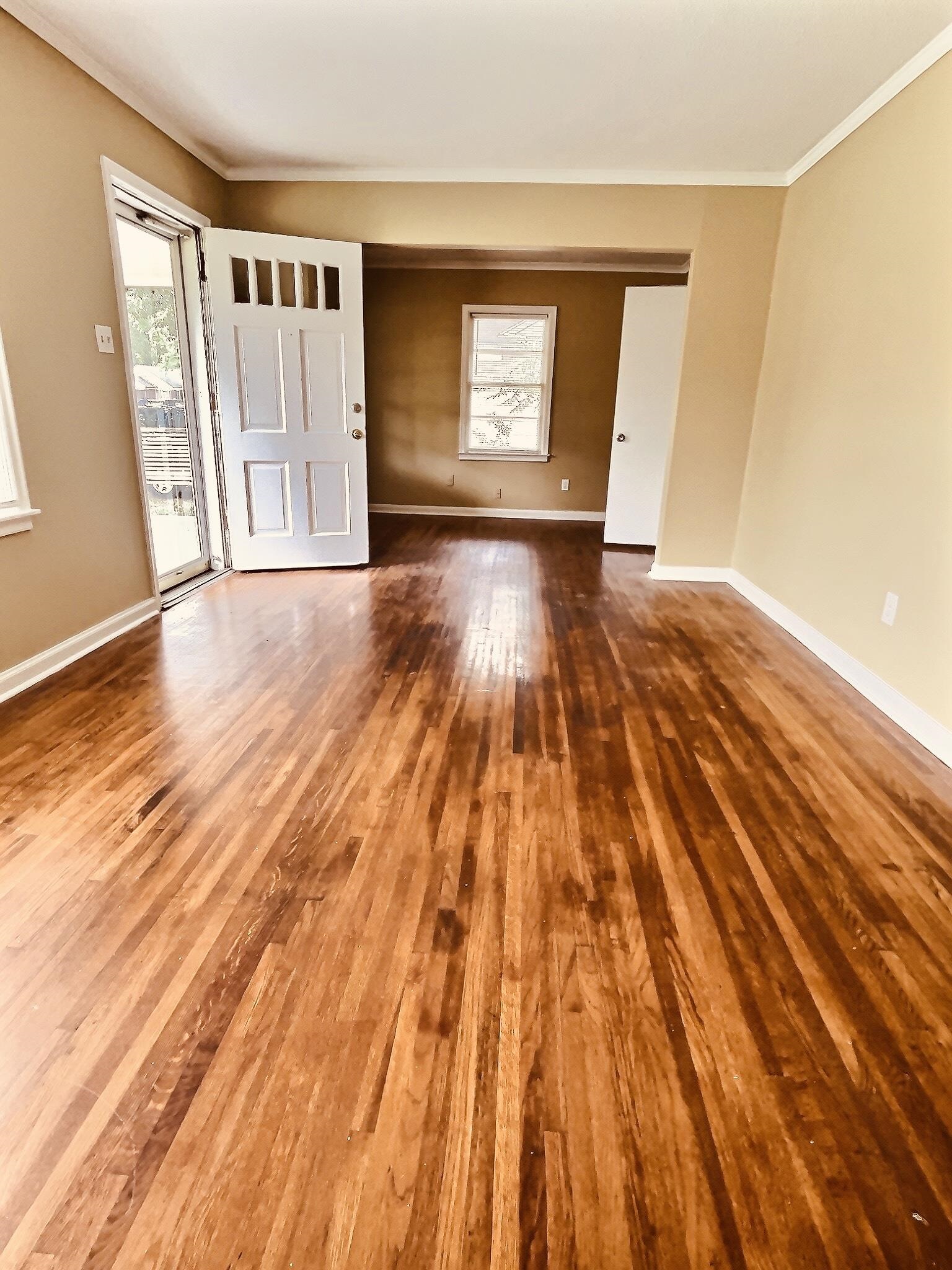 1405 South Perkins Road Memphis, TN 38117 - Photo 3 of 17 a view of an empty room with wooden floor and a window