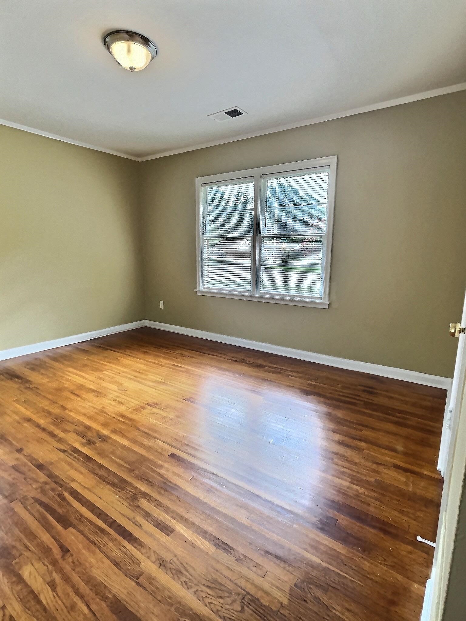1405 South Perkins Road Memphis, TN 38117 - Photo 4 of 17 a view of an empty room with wooden floor and a window