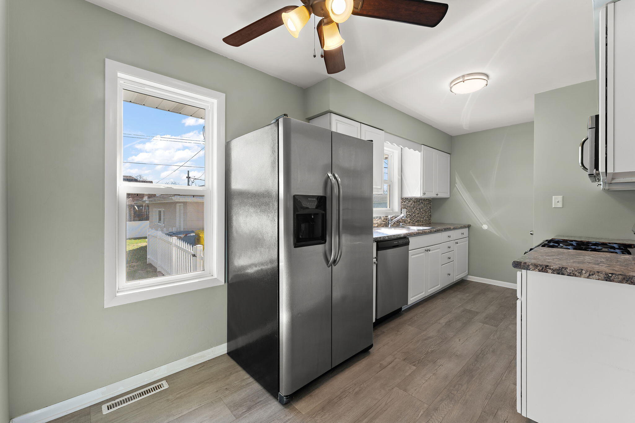 947 North Wood Street Griffith, IN 46319 - Photo 8 of 25 a kitchen with stainless steel appliances granite countertop a refrigerator a oven a sink with a dining table and chairs
