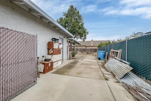 a view of a patio with a table and chairs