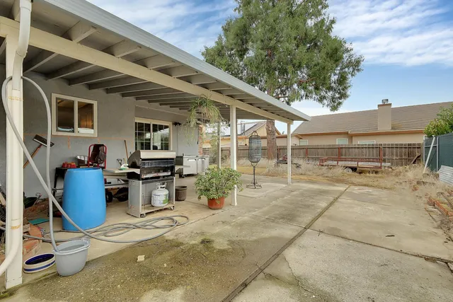 a view of a patio with table and chairs and potted plants