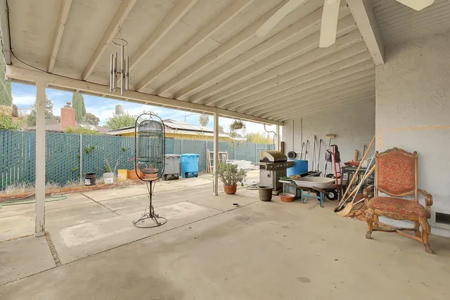 a view of a patio with a table and chairs