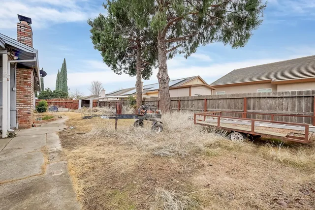 a view of a house with a yard and sitting area