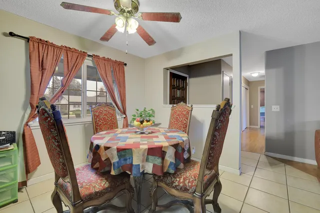 a view of a dining room with furniture and window