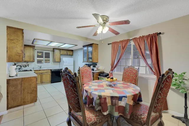 a view of a dining room with furniture and a chandelier
