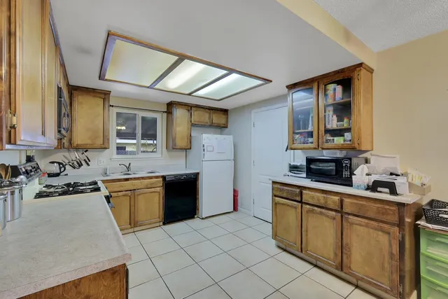a kitchen with stainless steel appliances granite countertop a sink stove and cabinets