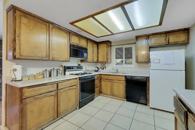 a kitchen with stainless steel appliances granite countertop a stove sink and cabinets