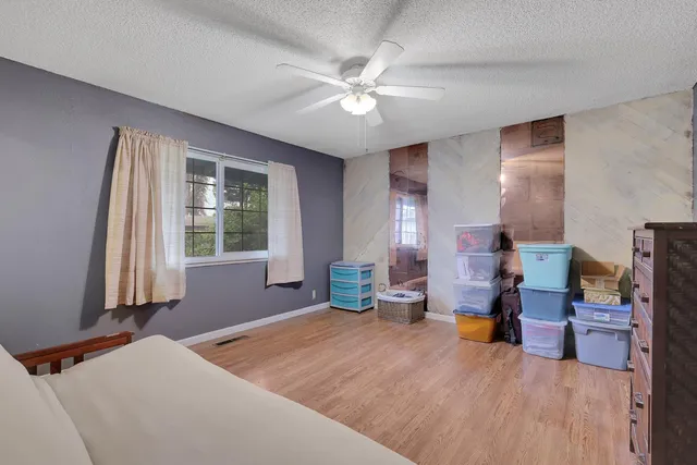 a bedroom with furniture and a large window