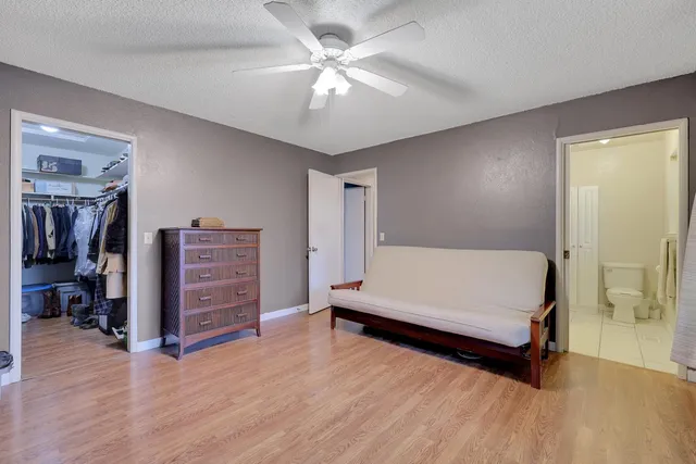 a spacious bedroom with a bed and a chandelier