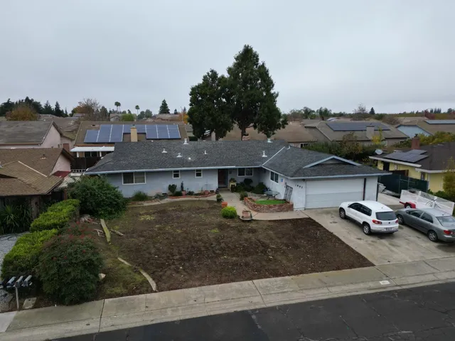 an aerial view of a house with garden space and street view