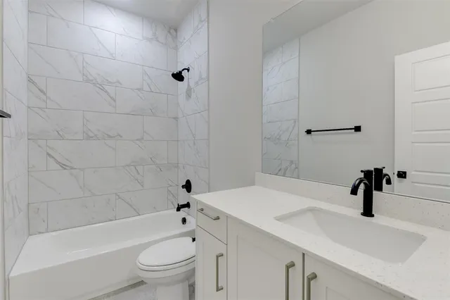 a bathroom with a sink a toilet and a bathtub