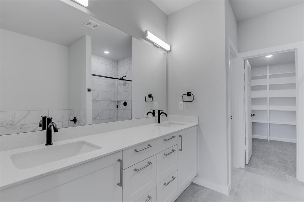 4218 Clovis Street Midlothian, TX 76065 - Photo 10 of 19 a spacious bathroom with a double vanity sink mirror and shower