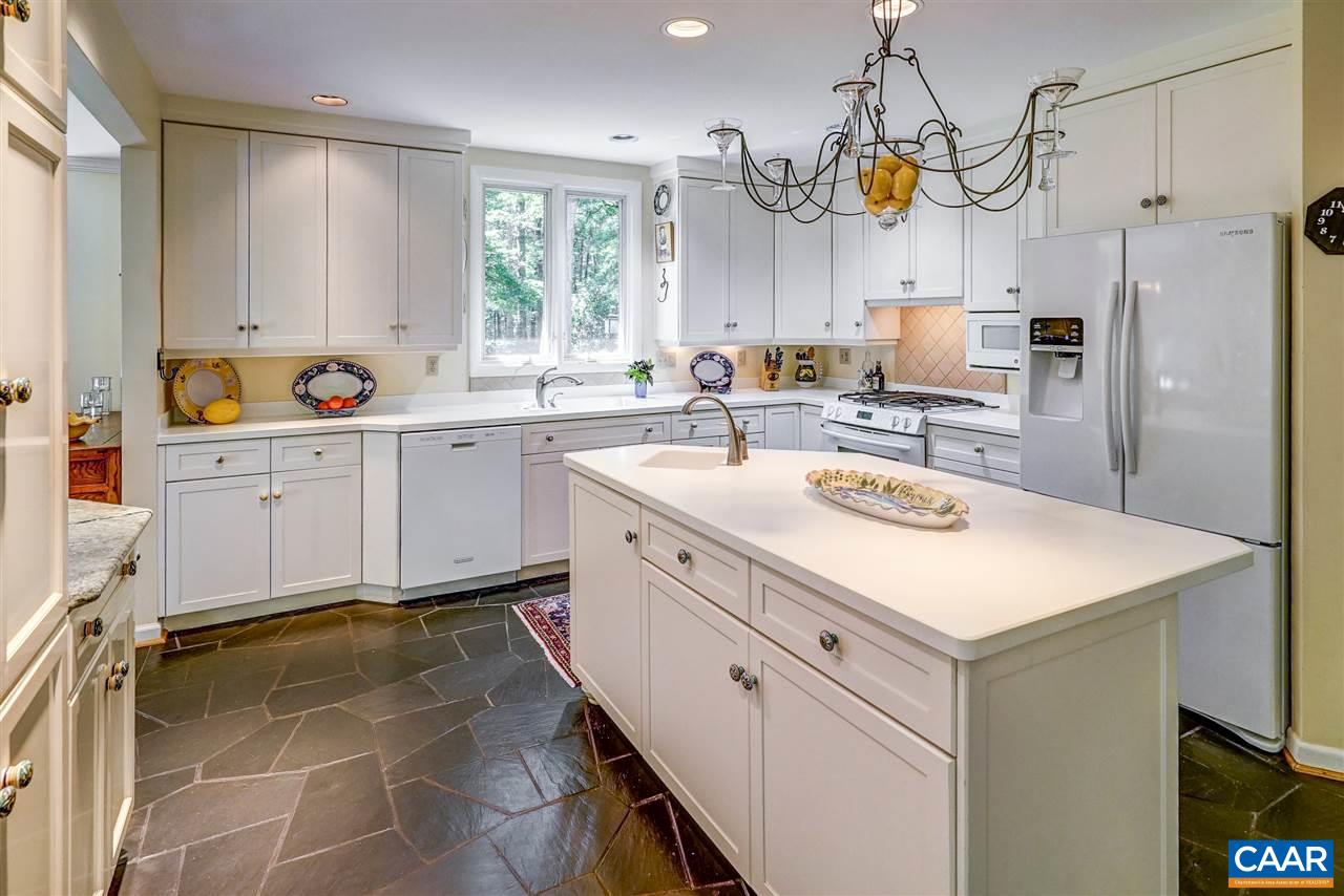1075 Richmond Road Keswick, VA 22947 - Photo 17 of 50 a kitchen with a sink a stove a refrigerator and white cabinets