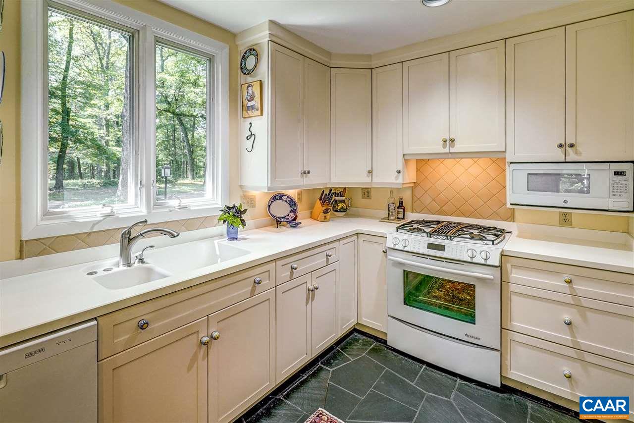 1075 Richmond Road Keswick, VA 22947 - Photo 18 of 50 a kitchen with granite countertop white cabinets and white appliances