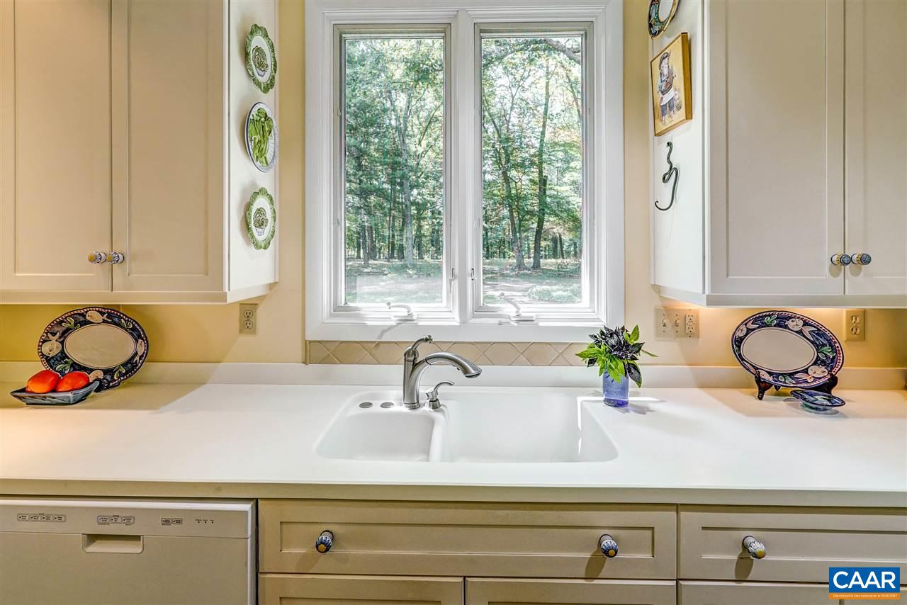 1075 Richmond Road Keswick, VA 22947 - Photo 19 of 50 a bathroom with a granite countertop sink and a window